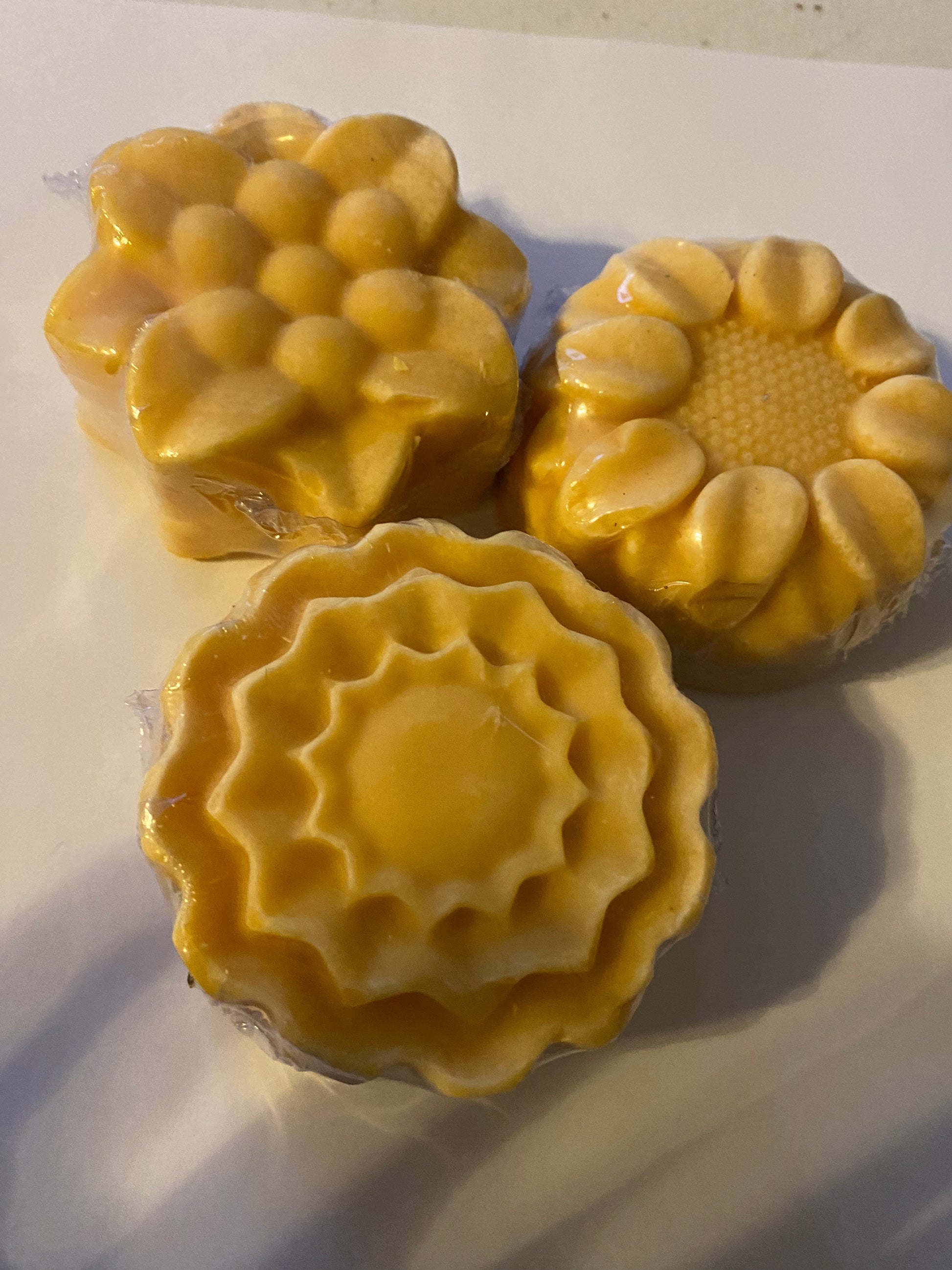 Three yellow flower shaped soap 