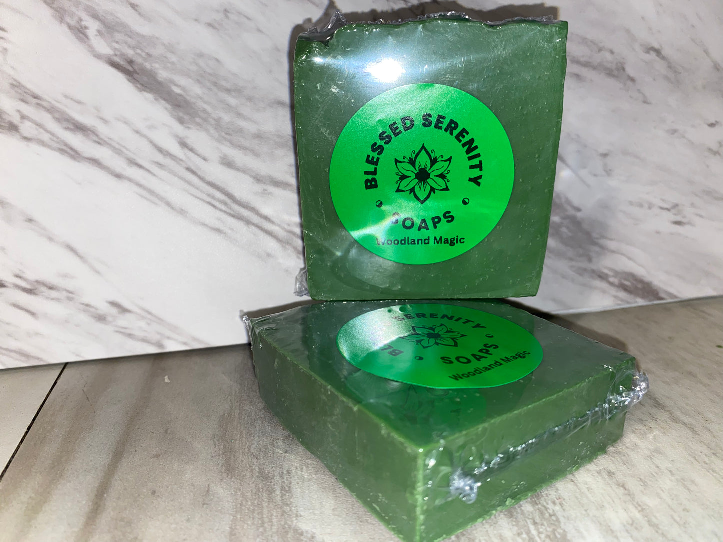 Forest green bar soap with green labels saying blessed Serenity Soaps woodland magic 