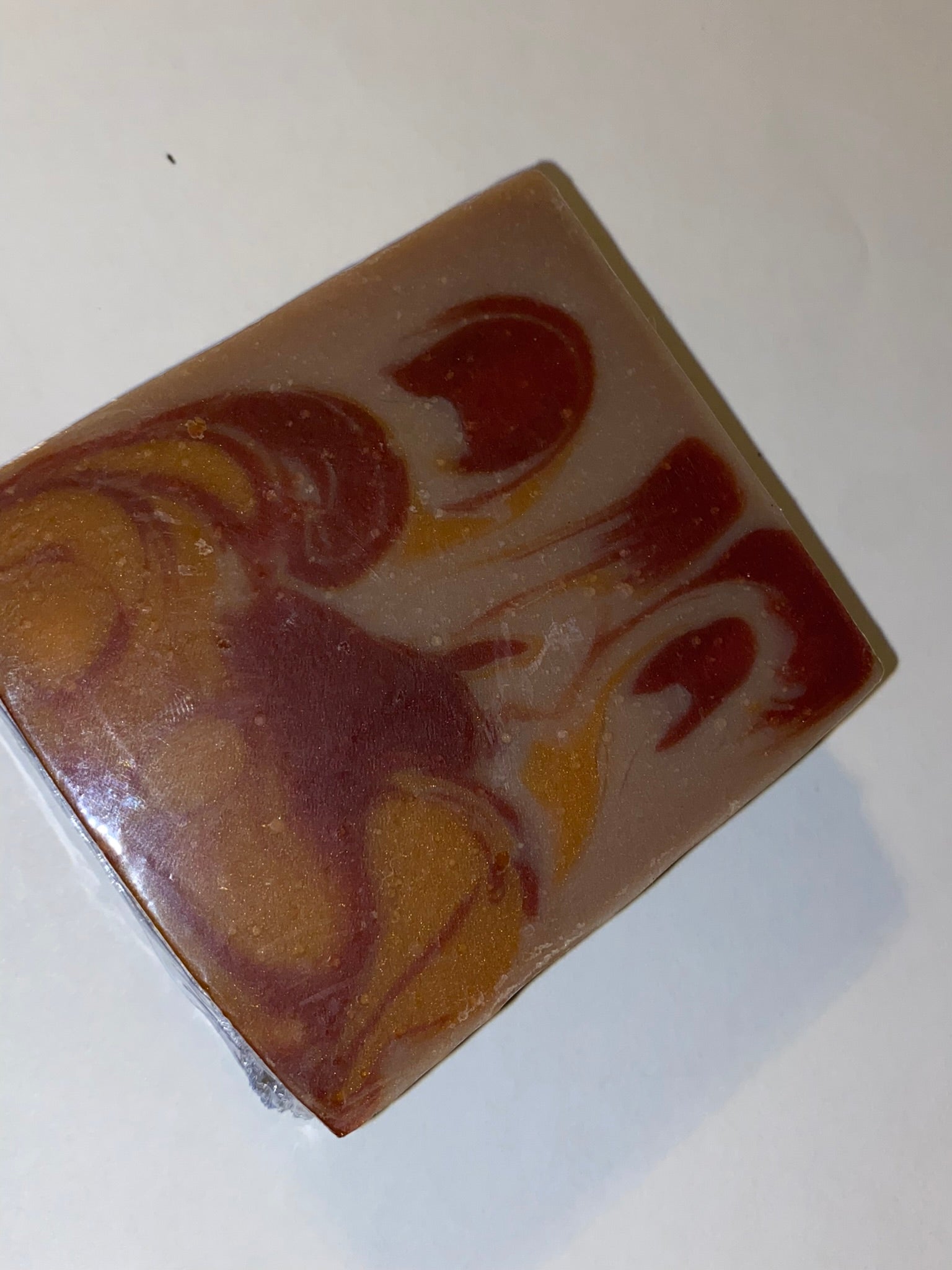 Dark cream with burgundy and orange swirl soap